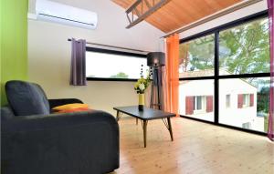 a living room with a couch and a table at Amazing Home In Sauveterre With Wifi in Sauveterre +25 photos