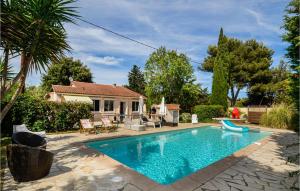 a swimming pool in front of a house at 3 Bedroom Awesome Home In La Seyne Sur Mer in Six-Fours-les-Plages