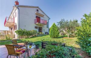 a house with a yard with chairs and a table at 6 Bedroom Nice Home In Segotici in Šegotići