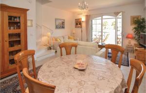 a dining room and living room with a table and chairs at Cozy Home In Aigues-mortes With Wifi in Aigues-Mortes