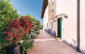 an alley with flowers and a building with a green door at Villa Bellavista in Lequio Tanaro +20 photos