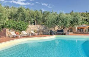 a swimming pool in a yard with chairs and trees at 24 Colle in Gaeta