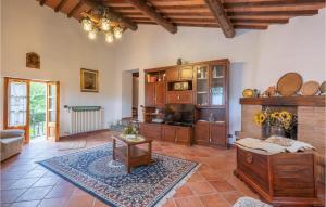 a living room with a couch and a table at Nice Home In Dicomano Fi With 4 Bedrooms, Private Swimming Pool And Wifi in Villore
