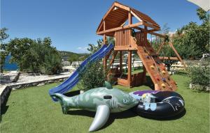 a playground with a toy shark and a slide at Gorgeous Home In Razanj With Wifi in Ražanj
