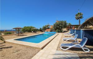 a swimming pool with two lounge chairs next to it at Nice Home In El Campello With Wifi in El Campello