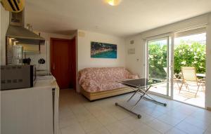 a kitchen with a bed and a table in a room at Nice Home In El Campello With Wifi in El Campello