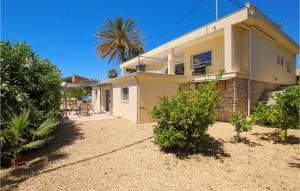 a house with a palm tree in front of it at Nice Home In El Campello With Wifi in El Campello +25 photos