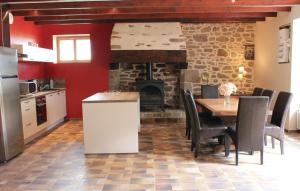a kitchen and dining room with a table and a fireplace at Gorgeous Home In Pleudihen Sur Rance in Mordreuc +22 photos