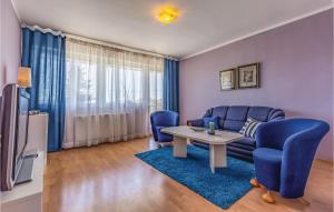een woonkamer met een blauwe bank en een tafel bij Awesome Apartment In Pula With Wifi in Pula