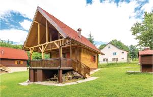 a large wooden house with a large deck at Beautiful Home In Licki Osik With Kitchen in Lički Osik