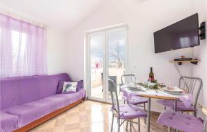 a living room with a purple couch and a table at Awesome Apartment In Bakarac With 1 Bedrooms And Wifi in Bakarac