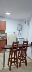 a kitchen with a wooden table and two chairs at Hermoso Apto Sector El Cable in Manizales