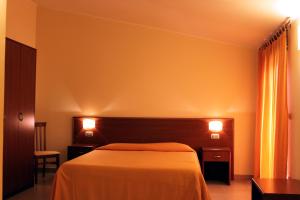 Postel nebo postele na pokoji v ubytování Hotel Sette E Mezzo