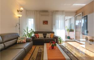 a living room with a couch and a table at Awesome Apartment In Ploce With Kitchen in Ploče
