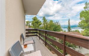 a balcony with patio furniture and a view of the water at Pet Friendly Apartment In Donji Karin With House Sea View in Donji Karin