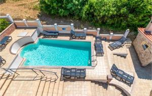 an overhead view of a swimming pool with patio furniture at Awesome Home In Dramalj With 7 Bedrooms, Wifi And Outdoor Swimming Pool in Dramalj