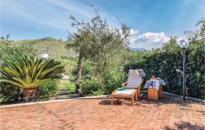 a brick patio with a chair and a table at Gorgeous Apartment In Castellabate Sa in Castellabate