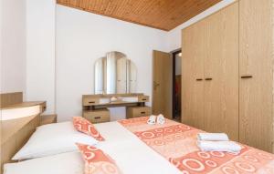 a bedroom with two beds and a mirror at Lovely Apartment In Kampor With House A Panoramic View in Kampor