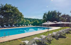 a swimming pool with lounge chairs and umbrellas at Castello Rocchette in Celleno
