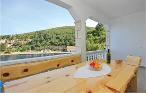 a table with a bowl of fruit on a balcony at Beautiful Apartment In Prigradica With House Sea View in Prigradica