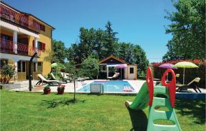 a backyard with a slide and a swimming pool at Awesome Home In Vinez With House A Panoramic View in Vinež