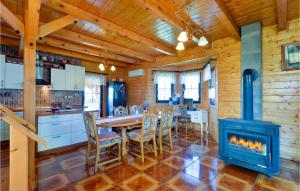 a kitchen and dining room with a wood stove at Nice Home In Donja Zelina in Donja Zelina