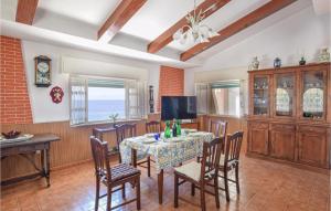 a dining room with a table and chairs and a television at Villa Annamaria in Lazzaro