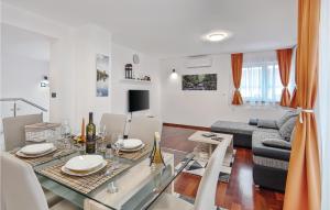 a dining room and living room with a dining table at Lovely Home In Varazdin With Kitchen in Varaždin