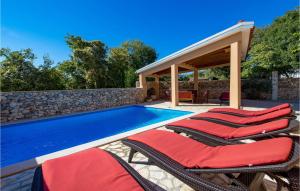 a swimming pool with lounge chairs next to a house at Cozy Home In Garica With Wifi in Garica