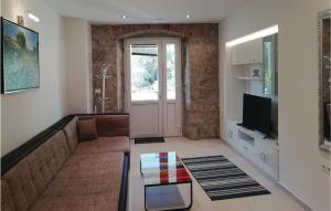 a living room with a couch and a tv at Beautiful Apartment In Ston With 2 Bedrooms And Wifi in Ston