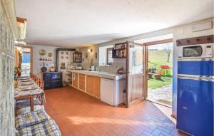a kitchen with an open door to a yard at Stunning Home In Castello Tesino With Kitchen in Castello Tesino