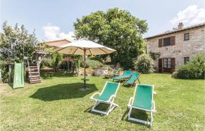 a group of chairs and an umbrella in a yard at Licia in Santa Maria di Ramici +26 photos