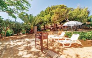 a patio with a table and two chairs and an umbrella at Gorgeous Home In Menfi Ag With Wifi in Porto Palo