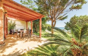 a patio with a table and chairs and the ocean at Gorgeous Home In Menfi Ag With Wifi in Porto Palo