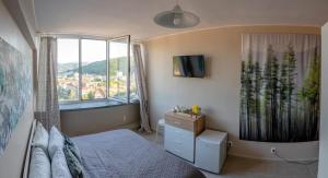 a small bedroom with a bed and a window at Adriano’s studio Gabrovo in Gabrovo