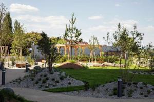 a garden with trees and a building in the background at My TrIIIple Ferienwohnung zwischen City und Prater in Vienna