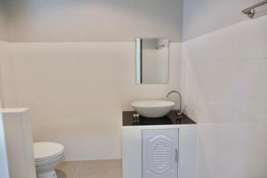 a white bathroom with a sink and a toilet at โรงแรมคอมม่อนเวลธ์ Commonwealth Hotel&Resort in Suan Phung +24 photos