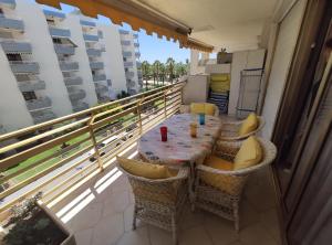 a table and chairs on a balcony with a view at Novelty I in Salou