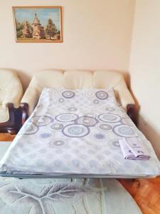 a bed with a blanket on top of it at Family apartment in the heart of Rivne in Rivne