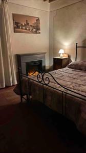 a bedroom with a bed and a fire place at Villa Terria in Bagni di Lucca