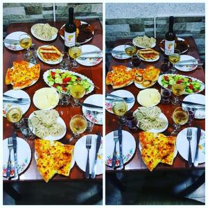 a table with plates of food and glasses of wine at Hotel Tskhumi in Kutaisi