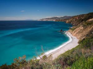 a view of the beach from a cliff at Apartamentos Balcón de Maro in Maro