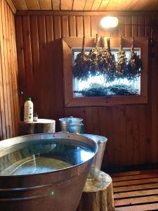 a kitchen with a tub in a wooden room at Karula Stay Sauna House in Karula National Park in Ähijärve