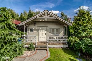 un cottage bianco con portico e panchina di szumidomek a Mielno