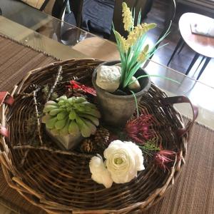 una cesta de mimbre con flores y plantas sobre una mesa en Petit Appart de Charme Eau chaude solaire Rénovation 2021 Wifi disponible Belvedere 5, en Saint-Luc