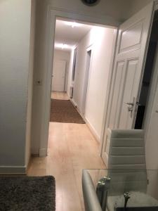 a hallway with a white door and a stairway at Unterkunft in Stuttgart in Stuttgart