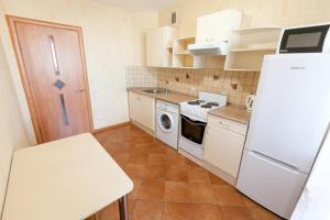 a kitchen with white appliances and a white refrigerator at Центр! Красноармейский 69б-13 in Barnaul