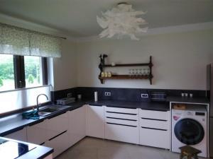 a kitchen with a sink and a washing machine at Apartament pod lipką in Lutowiska