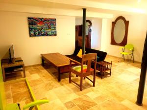 a living room with a table and a couch at Gîte La Glycine in Dun