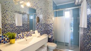 a bathroom with a toilet and a sink and a shower at Tabbu ibiza apartments in Playa d'en Bossa